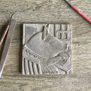 "Agnes Types Her Memoirs". Before firing and glazing, the clay tile is hand carved