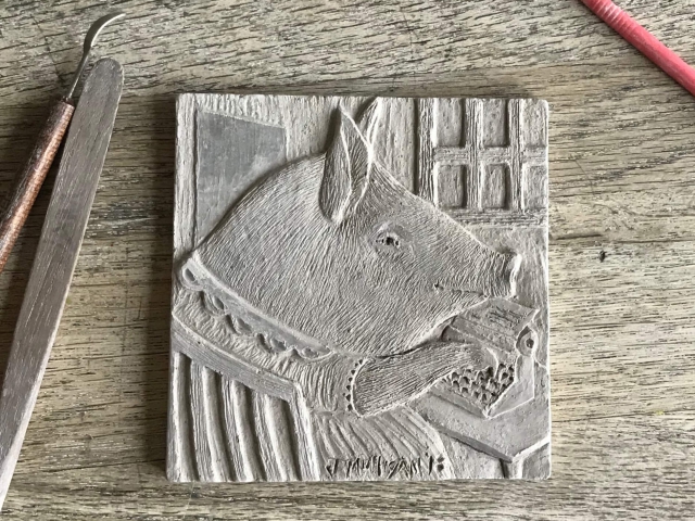 "Agnes Types Her Memoirs". Before firing and glazing, the clay tile is hand carved