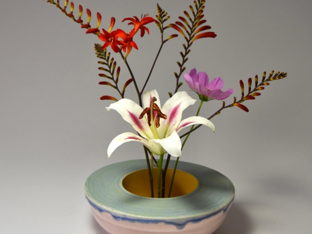Double Walled, pink, blue green and yellow low vase. Porcelain, glaze.